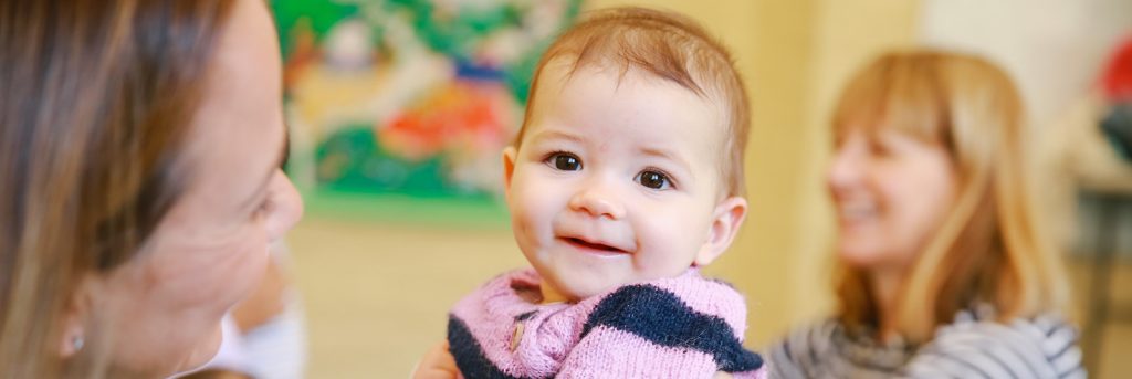 smiling baby with mum