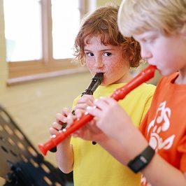 two boys playing recorder